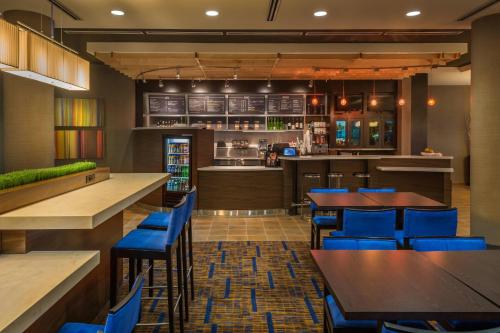 a restaurant with blue chairs and tables and a bar at Courtyard by Marriott Reno Downtown/Riverfront in Reno