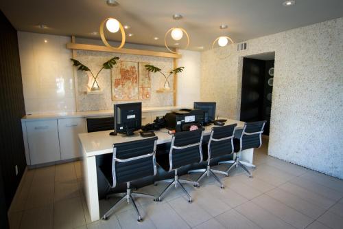 an office with a desk with four computer monitors on it at Scottsdale Parkview in Scottsdale
