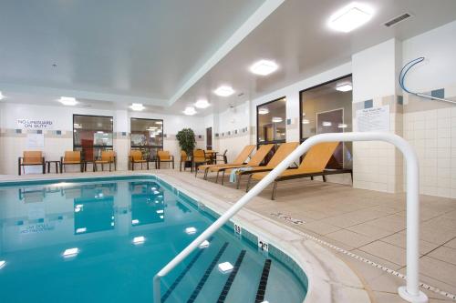 a pool at a hospital with chairs and tables at Courtyard Blacksburg in Blacksburg