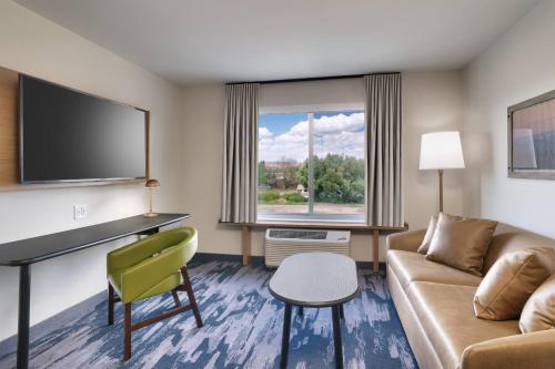 a living room with a couch and a tv at Fairfield Inn & Suites by Marriott Livingston Yellowstone in Livingston