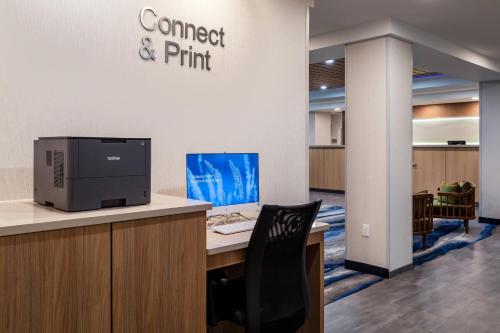 an office with a computer sitting on a desk at Fairfield Inn & Suites by Marriott Atlanta Stonecrest in Lithonia