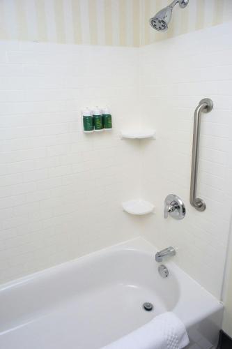 a white bathroom with a tub and a sink at Fairfield Inn & Suites by Marriott Millville Vineland in Millville