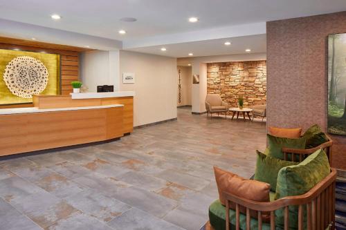 a lobby of a hospital with chairs and a counter at Fairfield Inn & Suites by Marriott Albany Airport in Albany