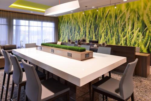 a large conference room with a large table and chairs at Courtyard by Marriott Saskatoon Airport in Saskatoon