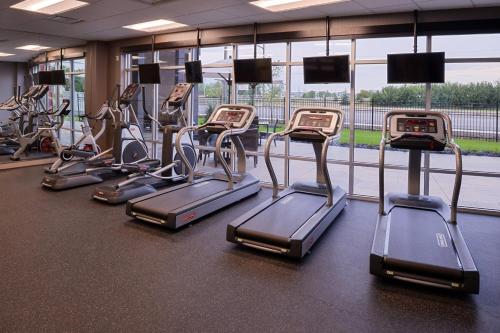 a gym with several rows of cardio machines at Courtyard by Marriott Saskatoon Airport in Saskatoon