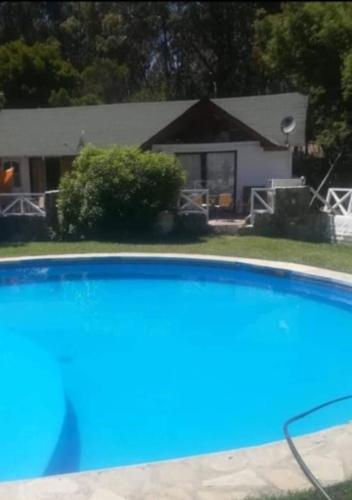 a close up of a swimming pool in front of a house at Alta Vista de Cahuil in Pichilemu