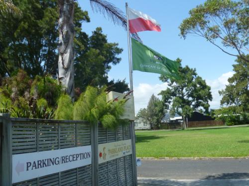 a flag and a flag pole in a park at At Parkland Place B&B in Whitianga