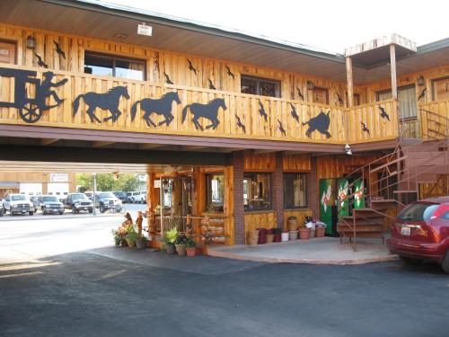 a building with horses painted on the side of it at Frontier Lodge in Lander