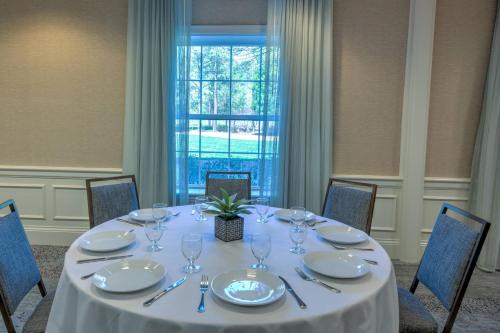 a table in a room with a white table cloth at Courtyard Chapel Hill in Chapel Hill