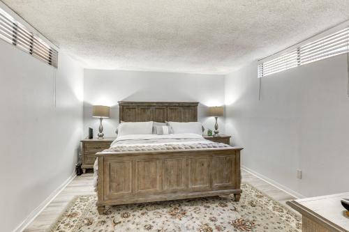 a bedroom with a large wooden bed and two lamps at Waterfront Condo with Dock Access in Carlsbad! in Carlsbad