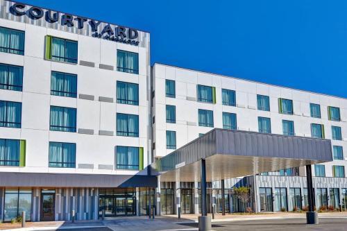 a rendering of the courtyard hotel in front of a building at Courtyard by Marriott Bentonville Rogers Promenade in Rogers