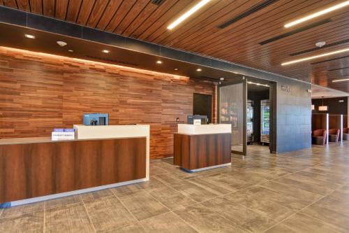 a lobby with a reception desk in a building at Courtyard by Marriott Bentonville Rogers Promenade in Rogers