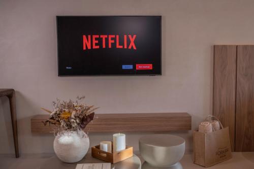 a living room with a tv on the wall at Forkira Luxury Hvar in Hvar