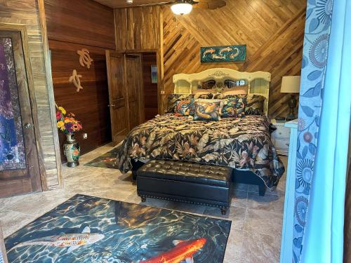 a bedroom with a bed in a room with wooden walls at Hawaii Magic Skies Farmstay in Hilo