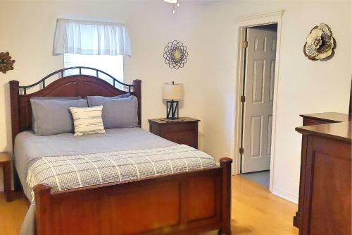 a bedroom with a bed and a lamp and a door at 24th Street House in Gulfport