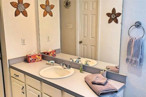 a bathroom with a sink and a large mirror at 24th Street House in Gulfport