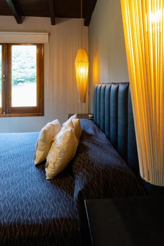 a bedroom with a bed with a pillow and a window at Portal de la Virgen in Villa General Belgrano
