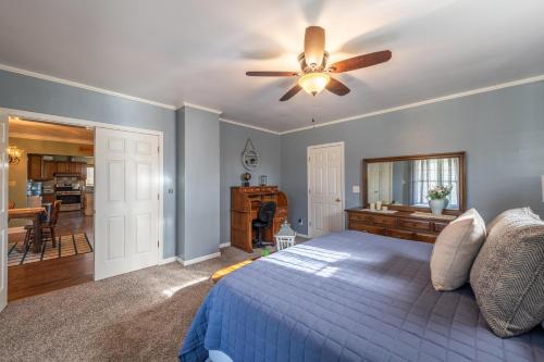 a bedroom with a bed and a ceiling fan at Maplewood Farmhouse + Hot tub in Howland Corners