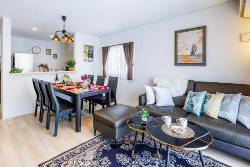 a living room with a couch and a table at New Villa! 15min drive to Naha airport# 2bathrooms in Itoman