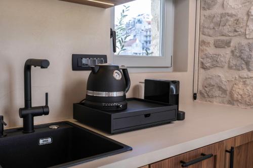 a coffeemaker sitting on a counter next to a sink at Forkira Luxury Hvar in Hvar