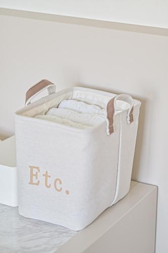 a white chest sitting on a white shelf at In Stay Guesthouse in Seogwipo