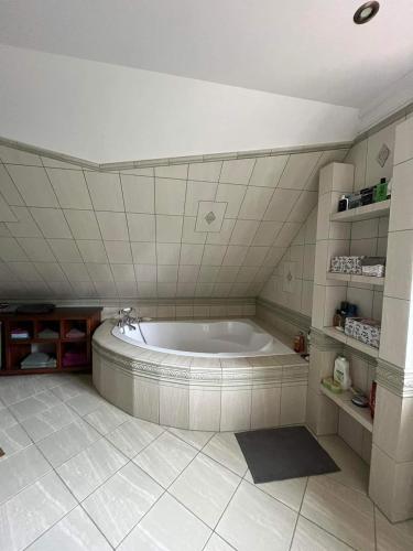 a bathroom with a large tub in a room at Lawendowy Dom in Spychowo