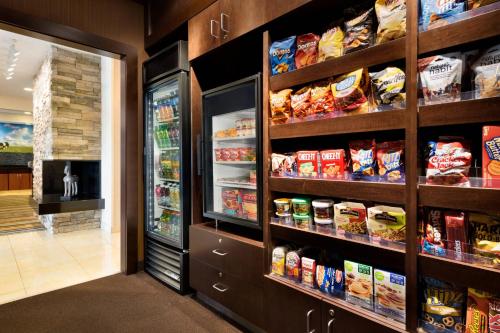 a grocery store aisle with food in the refrigerator at Fairfield Inn Kankakee Bourbonnais in Bourbonnais