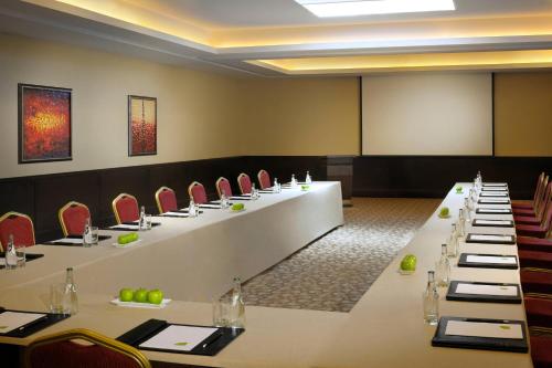 a conference room with long tables and chairs at Courtyard by Marriott Riyadh Diplomatic Quarter in Riyadh