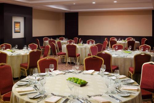 a conference room with tables and chairs with wine glasses at Courtyard by Marriott Riyadh Diplomatic Quarter in Riyadh