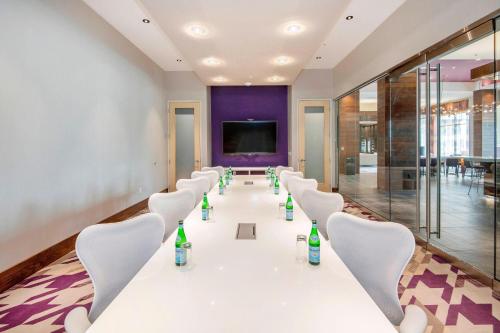 a conference room with a long table and chairs at Courtyard by Marriott Raleigh Cary/Parkside Town Commons in Cary