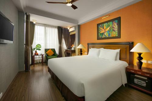 a bedroom with a large white bed in a room at Classic Street Hotel in Hanoi