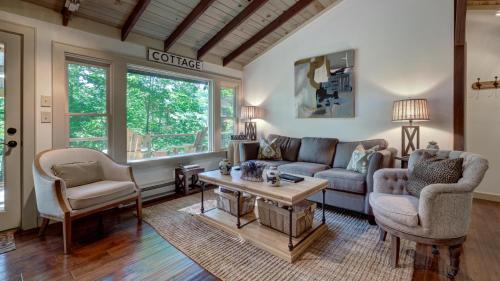 a living room with a couch and two chairs and a table at Mountain Laurel Tree House in Highlands