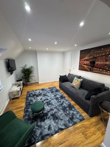 a living room with a couch and a rug at A luxurious coach house in Colchester