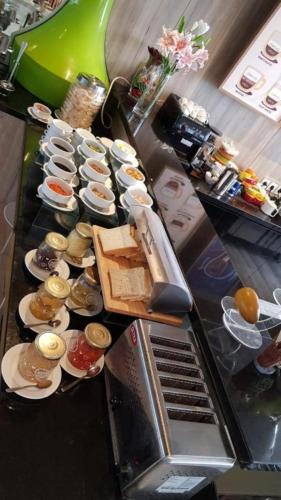 a buffet line with sandwiches and other foods on plates at MaxOneHotels @Balikpapan in Balikpapan