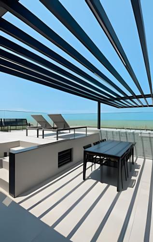 a table on the upper deck of a house at Loft luxo p/ 4 pessoas, a 50m do mar in Ilha da Restinga