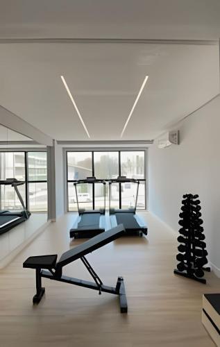 a gym with two treadmills and a treadmill at Loft luxo p/ 4 pessoas, a 50m do mar in Ilha da Restinga