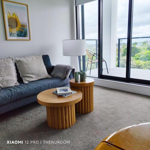 a living room with a couch and a table at Auckland Birkenhead BNB in Auckland