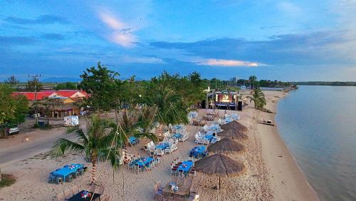 an overhead view of a beach with chairs and umbrellas at The Last Beach House in Kampot