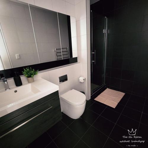 a bathroom with a toilet and a sink and a shower at Auckland Birkenhead BNB in Auckland