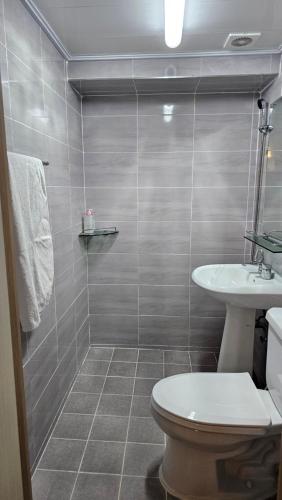a bathroom with a toilet and a sink at Dada House in Seoul