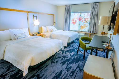 a hotel room with two beds and a desk and a window at Fairfield Inn & Suites Scranton Montage Mountain in Moosic