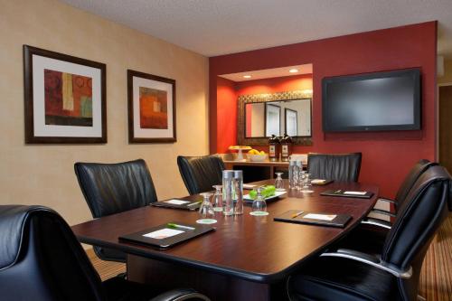 a conference room with a table and chairs and a flat screen tv at Courtyard Sacramento Airport Natomas in Sacramento