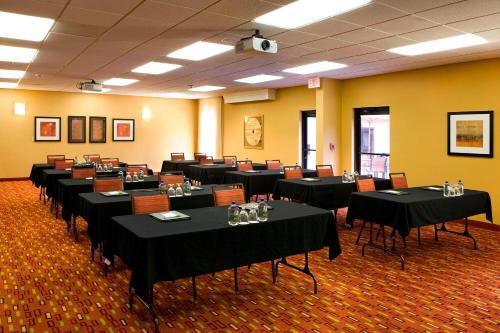 a room filled with tables and chairs with black table cloth at Courtyard Sacramento Airport Natomas in Sacramento