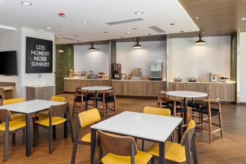 a restaurant with tables and chairs and a counter at Fairfield Inn & Suites Morganton Historic Downtown in Morganton
