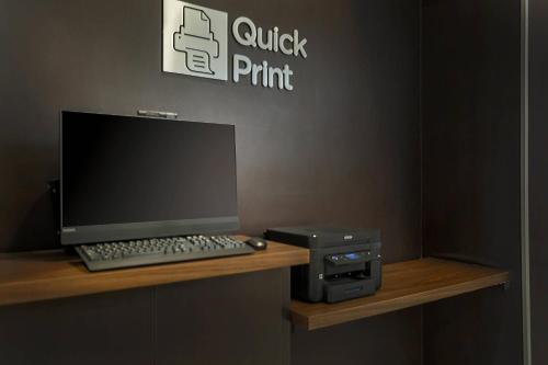 a computer and a printer sitting on a desk at Courtyard Tampa Brandon in Tampa
