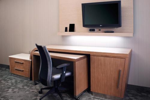 a desk with a chair and a television on top at Courtyard Toledo Rossford/Perrysburg in Rossford