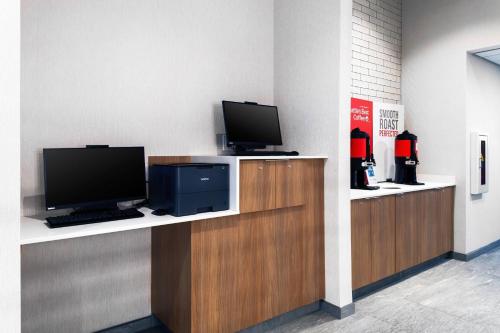 a reception desk with a tv and a computer monitor at Fairfield Inn & Suites Springfield Enfield in Springfield