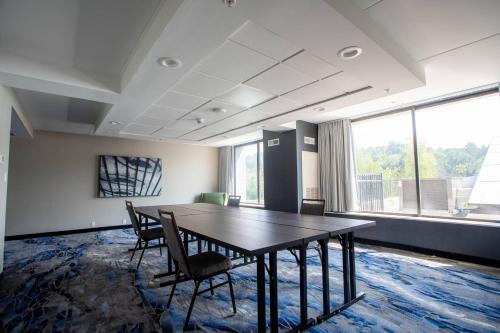 an office room with a table and chairs and a large window at Fairfield Inn & Suites Springfield Enfield in Springfield
