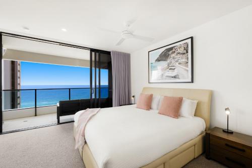 a bedroom with a large bed and a large window at Oracle Broadbeach Tower 1 Lvl 20 Free parking - GC Getaways in Gold Coast