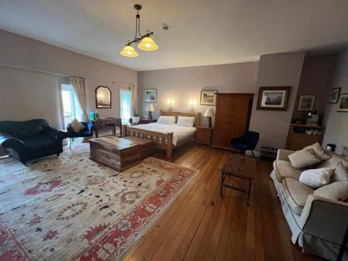 a living room with a bed and a couch at The Old Flax Mill Yoga Retreat in Coleraine